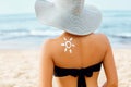 Skin care. Sun protection. Beauty Woman apply sun cream. Woman With Suntan Lotion On Beach In Form Of The Sun. Royalty Free Stock Photo