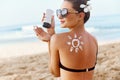 Skin care. Sun protection. Woman apply sun cream. Girl Holding Moisturizing Sunblock. Woman With Suntan Lotion On Beach In Form Of Royalty Free Stock Photo