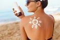 Sun shape created from sunscreen lotion on young woman`s back. Skin protection.Skin and Body Care.Facial  treatment. Sun Cream Sa Royalty Free Stock Photo