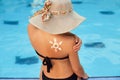 Skin care. Sun protection. Woman apply sun cream. Woman With Suntan Lotion Near Pool In Form Of The Sun. Royalty Free Stock Photo