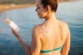 Skin care. Sun protection. Woman apply sun cream. Woman With Suntan Lotion On Beach In Form Of The Sun. Royalty Free Stock Photo