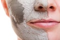 Skin care. Woman applying clay mask on face. Spa. Royalty Free Stock Photo