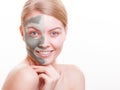 Skin care. Woman applying clay mask on face. Spa.