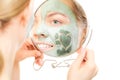 Skin care. Woman in clay mud mask on face. Beauty. Royalty Free Stock Photo