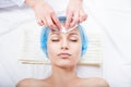 Skin care - woman cleaning face by beautician