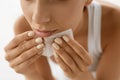 Skin Care. Woman Cleaning Face With Oil Absorbing Papers.