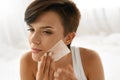 Skin Care. Woman Cleaning Face With Oil Absorbing Papers.