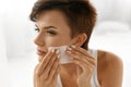 Skin Care. Woman Cleaning Face With Oil Absorbing Papers.