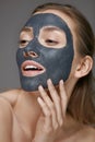 Skin care. Woman face with cosmetic spa clay mask closeup Royalty Free Stock Photo