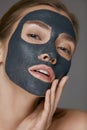 Skin care. Woman face with cosmetic spa clay mask closeup Royalty Free Stock Photo