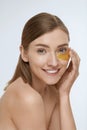 Skin care. Woman face with under eye gold patch, beauty mask Royalty Free Stock Photo
