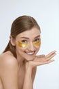 Skin care. Woman with under eye gold patch, beauty mask Royalty Free Stock Photo