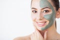 Skin Care. Young woman with cosmetic clay mask holding cucumber Royalty Free Stock Photo