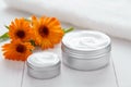 Skin cleansing cosmetic cream with calendula flowers vitamin spa lotion Royalty Free Stock Photo