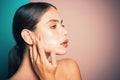 Skin hydrated regularly moisturizing cream. Taking good care of her skin. Beautiful woman spreading cream on her face Royalty Free Stock Photo