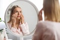 Skin Problems Concept. Upset Middle Aged Woman Looking At Mirror And Touching Face, Royalty Free Stock Photo