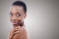 Skin so soft...A young african woman looking over her bare shoulder - copyspace. Royalty Free Stock Photo