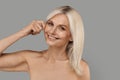 Skin Tightening Concept. Happy Beautiful Mature Woman Touching Her Cheek Royalty Free Stock Photo
