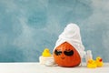 Skincare accessories and pumpkin with eye patches on blue background Royalty Free Stock Photo