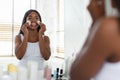 Daily Skincare. Beautiful Smiling Black Woman Cleansing Skin With Cotton Pads Royalty Free Stock Photo