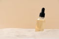 Skincare with beauty cosmetic face serum. Glass bottle with a pipette on a natural background with sand. Dry skin care product.