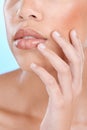 Skincare, beauty and mouth of woman with hands on blue background for wellness, cosmetics and makeup. Dermatology