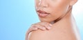 Skincare, beauty and woman with hand on shoulder with zoom, blue background and mockup space. Health, dermatology and