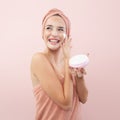 Skincare, cheerful young woman laughing, applying moisturizing cream on face, lotion or mask for skin lifting and anti-aging, Royalty Free Stock Photo