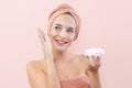 Skincare, cheerful young woman smiling, applying moisturizing cream on face, lotion or mask for skin lifting and anti-aging, wears Royalty Free Stock Photo