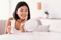 Young woman cleaning her face with cotton pad Royalty Free Stock Photo