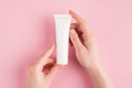 Skincare concept. Top above overhead pov first person view photo of female hands holding white tube of cream isolated on pastel Royalty Free Stock Photo