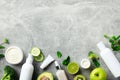 Skincare cosmetics set with green fruits, vegetables, mint leaves on stone table Royalty Free Stock Photo