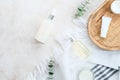Skincare cosmetics in white bottles and containers with green eucalyptus leaves on stone table. Natural organic beauty products Royalty Free Stock Photo