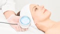 Skincare cosmetology facial procedure. Beauty woman face. Blue light medical therapy. Specialist hand Royalty Free Stock Photo