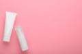 Skincare cream in white plastic tubes on a pink background flat lay. Set of cosmetic beauty products for skin cleansing and face Royalty Free Stock Photo