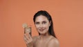 Skincare creative concept. Woman holding glass of water with lime citrus fruit slices, smiling at the camera. Royalty Free Stock Photo