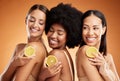 Skincare, diversity and women, beauty and lemon for health, wellness and nutrition on orange studio background. Friends