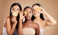 Skincare, diversity and women with fruit, cosmetics and dermatology with friends on brown studio background. Face