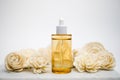 The skincare or facial serum with flower on white background. Luxury and beauty concept . Mock up bottle of amber glass dropper