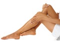 Skincare, legs and woman on studio floor for grooming, hygiene and soft skin on white background. Leg, beauty and girl