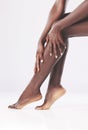 Skincare, legs and woman in studio for shaving, cleaning and grooming on white background mockup. Beauty, feet and black