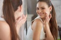 Skincare. Portrait of a Beautiful Smiling Woman With Cream on He