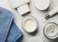 Skincare products.Cream jars,lotion, exfoliating cream and a blue towel