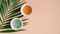 Skincare pure clay face masks with tropical palm leaf on peach background. Natural organic SPA cosmetic product, facial skin