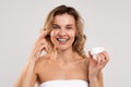 Skincare Routine. Attractive Middle Aged Woman Applying Moisturizing Cream On Face Royalty Free Stock Photo