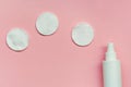 makeup removing, white facial cotton pads and bottle of micellar water, woman skin and body care product isolated on pastel pink