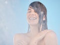 Skincare, shower and woman cleaning, happy and relax, wellness and water splash on blue background. Hair, model and girl