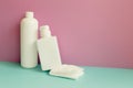 Skincare soap, shampoo bottle, shower towel on mint green table. pink wall background Royalty Free Stock Photo