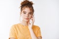 Skincare, tenderness fashion concept. Sensual attractive redhead girl freckles curly hairbun wear orange t-shirt look Royalty Free Stock Photo