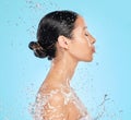 Skincare, water and profile of woman on blue background for wellness, healthy skin and cleaning in studio. Beauty Royalty Free Stock Photo